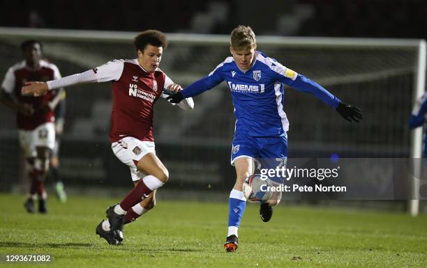 Scott Robertson of Gillingham moves forward with the ball under pressure from Shaun McWilliams during the Sky Bet League One match between...