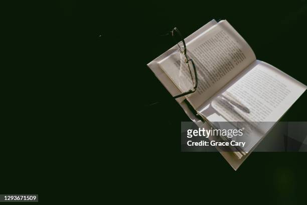 eyeglasses rest on open book - reading glasses top view stock pictures, royalty-free photos & images