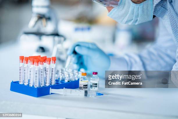 clinical trials by scientist for the covid-19 vaccine - criminal trial stock pictures, royalty-free photos & images