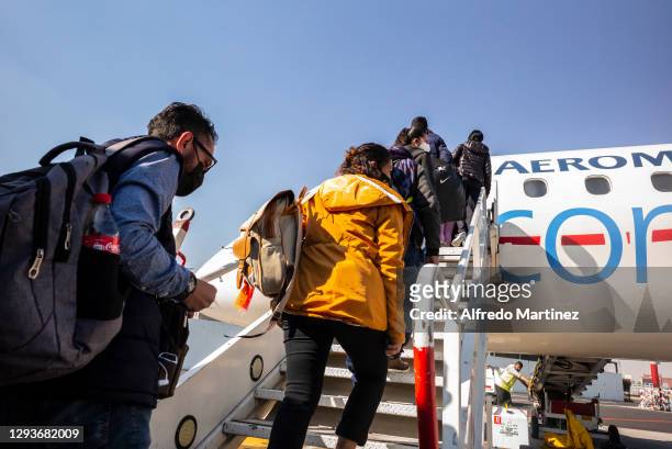 Passengers board flight of the Aeromexico airline on December 28, 2020 in Mexico City, Mexico.