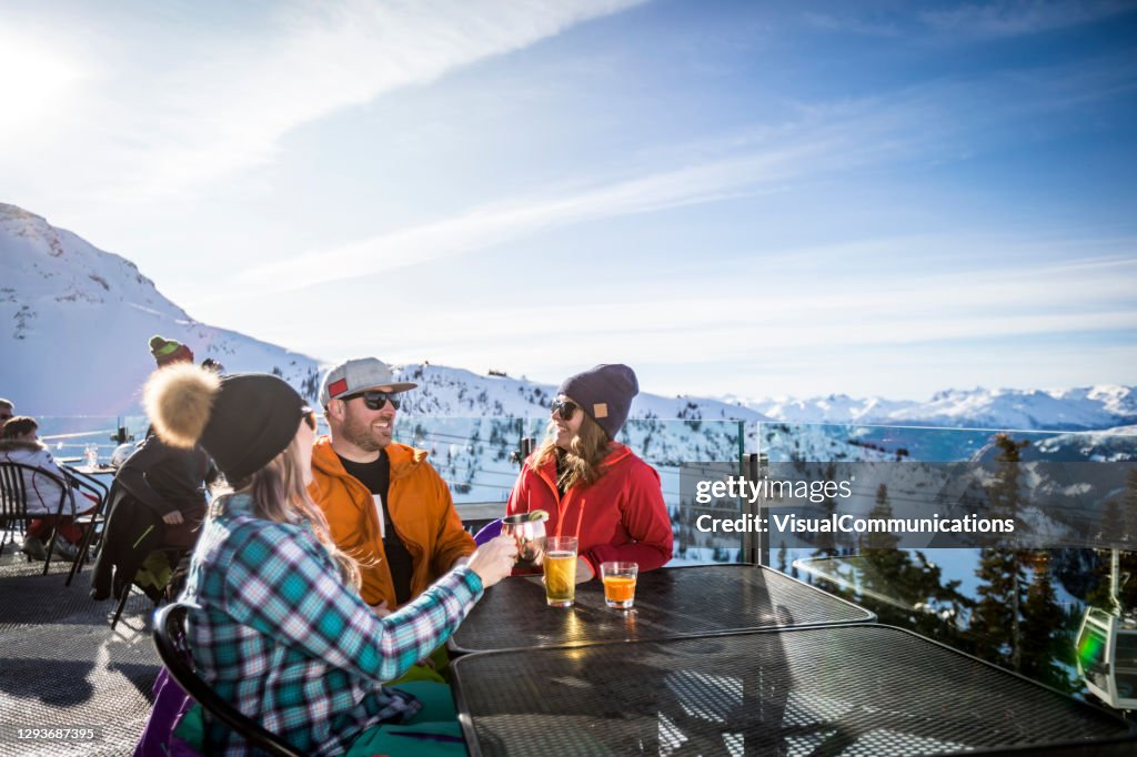 Gruppe von Freunden genießen Apres-Ski auf dem Gipfel des Whistler Berges.
