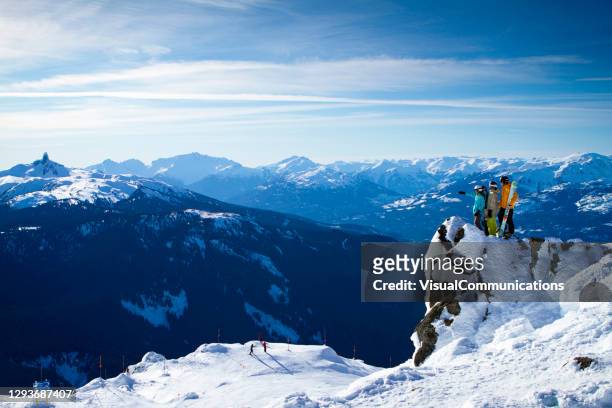 group of friends skiing and snowboarding at whistler blackcomb ski resort. - british columbia winter stock pictures, royalty-free photos & images