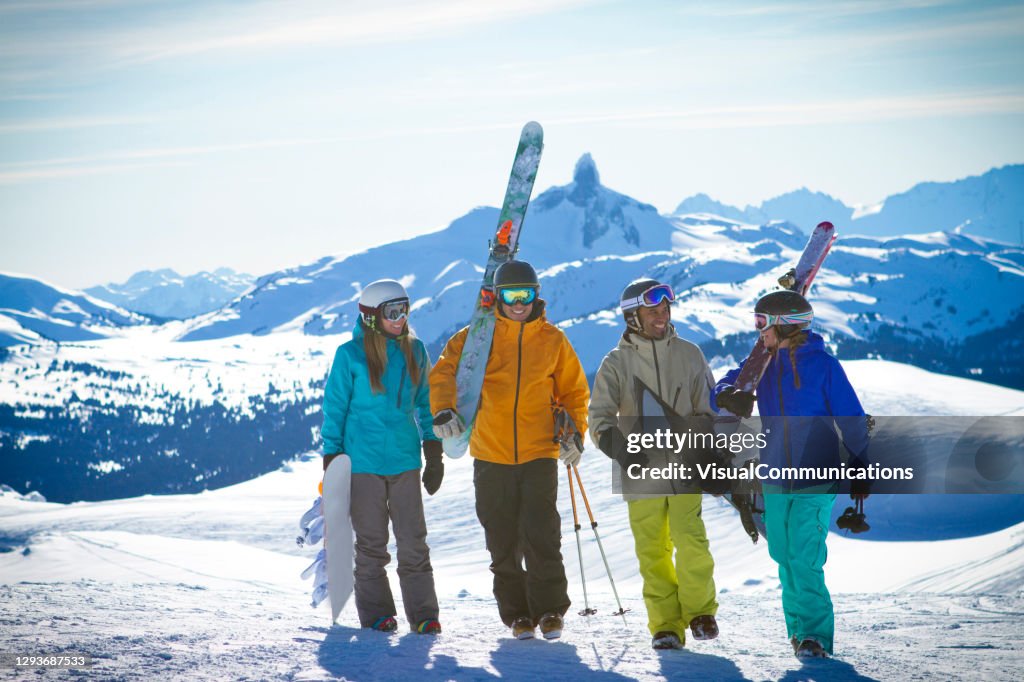 Group of friends skiing and snowboarding at Whistler Blackcomb ski resort.