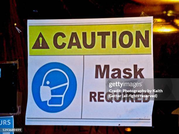 information signage on a storefront window during the coronavirus pandemic - contagion film title stock pictures, royalty-free photos & images