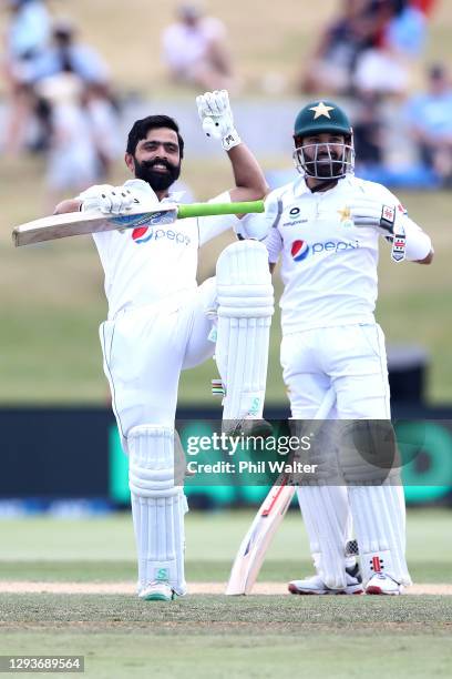 Fawad Alam of Pakistan celebrates his century with Mohammad Rizwan during day five of the First Test match in the series between New Zealand and...