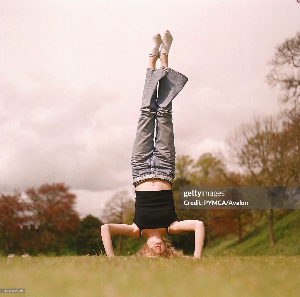 Girl doing a hand-stand on the field at Cardiff 2000's