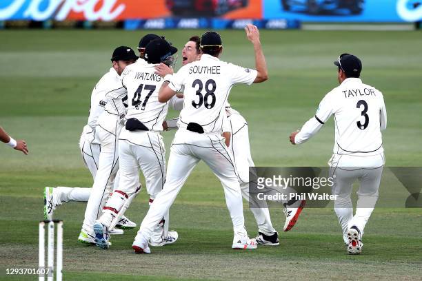 Mitchell Santner and New Zealand celebrate the final wicket of Naseem Shah of Pakistan to win the match during day five of the First Test match in...