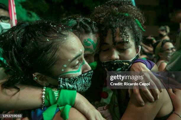 Pro-choice demonstrators hug celebrating after the right to an abortion is legalized on December 29, 2020 in Buenos Aires, Argentina. The proposal...