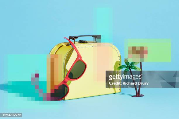 A pixelated suitcase with a pair of sunglasses and a palm tree