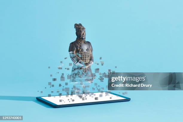 a terracotta soldier figurine emerging from a digital tablet - appearance icon stock pictures, royalty-free photos & images