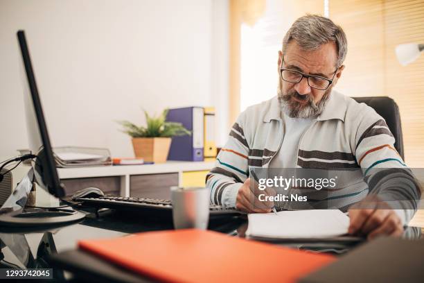 the businessman signs the document - man signing paper stock pictures, royalty-free photos & images