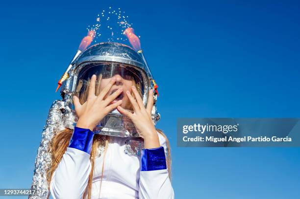 portrait of girl wearing space helmet - astronaut hand stock pictures, royalty-free photos & images