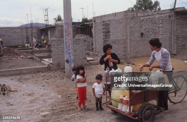 Mexico City, Chalco District, Itinerant Water Salesman, He Loads Up With Water And Cycles Around Selling It By The Litre,
