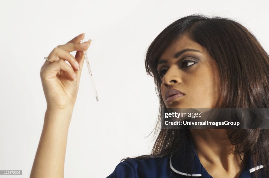 Nurse holding thermometer