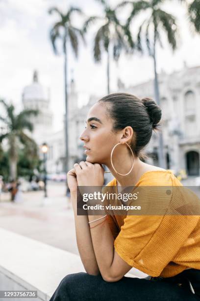 woman daydreaming in the city - cuban people stock pictures, royalty-free photos & images