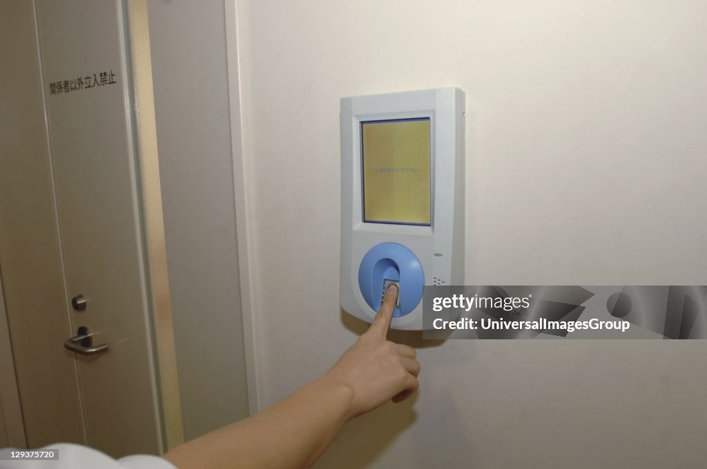 Japan, Kyoto, Japanese Red Cross Hospital, nurse using fingerprint security system to enter ward