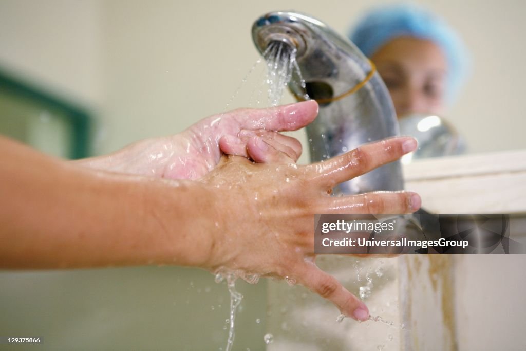 Close up of surgeon scrubbing her hands before going into surgery
