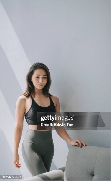 Asian Chinese Beautiful Woman With Yoga Pants And Sport Bra Beside Sofa  High-Res Stock Photo - Getty Images