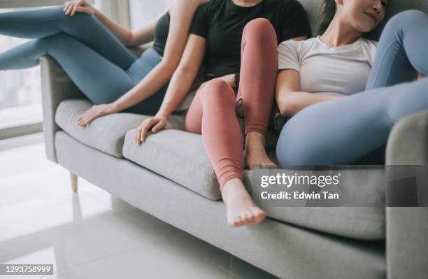 asian chinese group of female with yoga clothing sitting on sofa posing in living room - leggings stock pictures, royalty-free photos & images