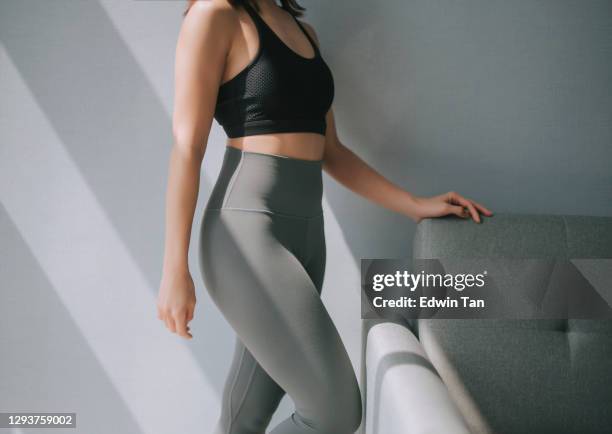 side view mid section of asian chinese woman with yoga pants sport clothing sexual sporty sportive tempting beautiful attractive nice round tight pants leggings - beautiful hips photos et images de collection