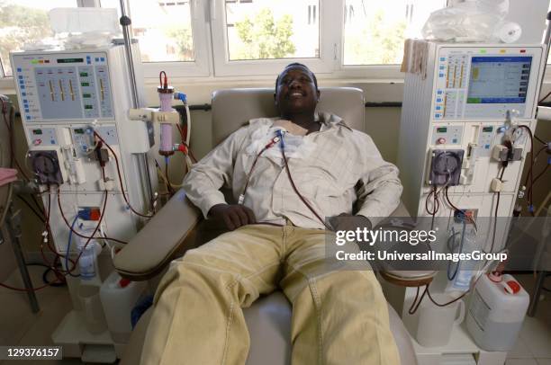 Man laying while attached to dialysis machine