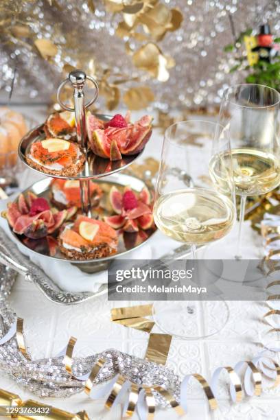 festive party table with seafood appetizer etagere tower and wine - elegant cocktail party stock pictures, royalty-free photos & images