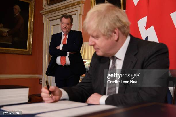Chief negotiator David Frost looks on as Prime Minister, Boris Johnson poses for photographs after signing the Brexit trade deal with the EU in...