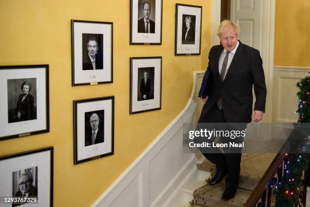 Prime Minister, Boris Johnson poses for photographs on the stairs after signing the Brexit trade deal with the EU in number 10 Downing Street on...