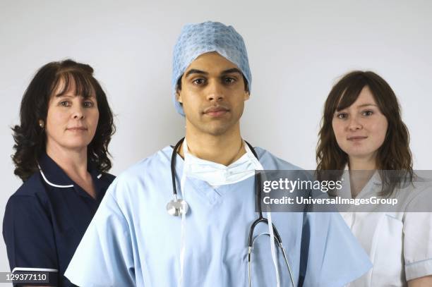 Studio portrait of surgeon and two hospital nurses