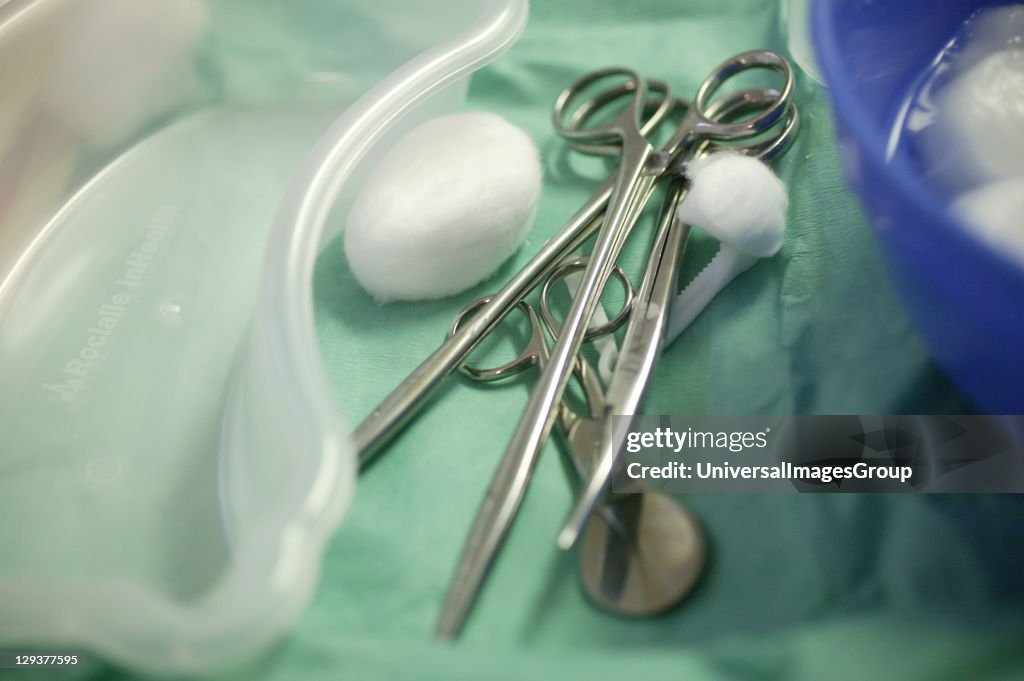 Medical tools including forceps, scissors and cotton wool