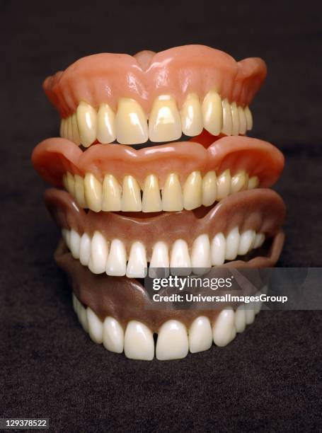 Stack of dentures, Dentures or false teeth are made from an acrylic base on which acrylic or ceramic teeth are mounted. Dentures are custom made per...