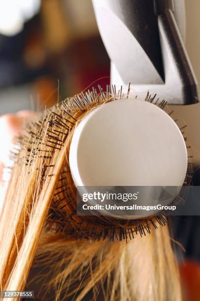 Close up of hair being brushed and dried with hair dryer