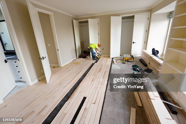 instalación de pisos de madera de arce con pistola de clavos en curso - madera noble fotografías e imágenes de stock