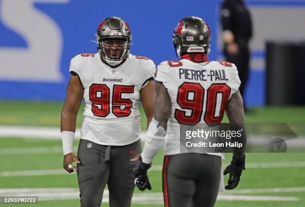 Jeremiah Ledbetter of the Tampa Bay Buccaneers celebrates a quarterback sack with teammate Jason Pierre-Paul during the second quarter of the game...