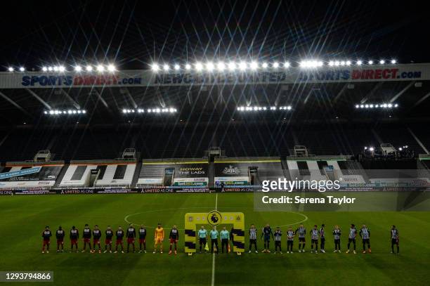 Players and Officials line up during the Premier League match between Newcastle United and Liverpool at St. James Park on December 30, 2020 in...