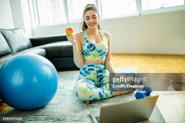 personal fitness trainer giving advice online on laptop at home during new-normal - nutrition coach stock pictures, royalty-free photos & images
