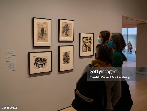 Viewers look at a series of drawings created in the 1950's December 30, 2020 at the Museum of Modern Art in New York City. Museum of Modern Art goers...