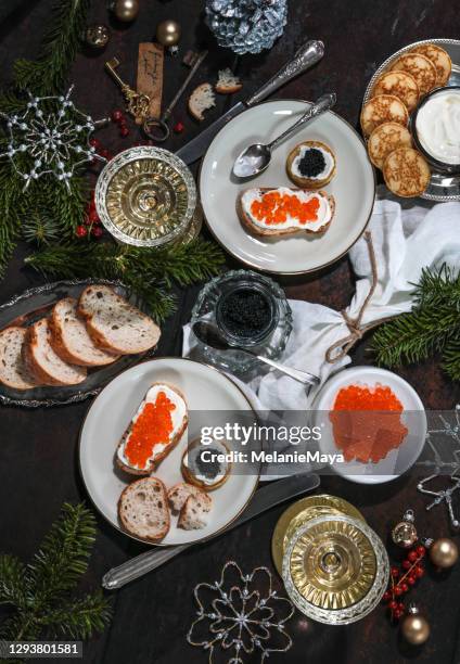 festive christmas table with caviar blinis and champagne - red caviar stock pictures, royalty-free photos & images