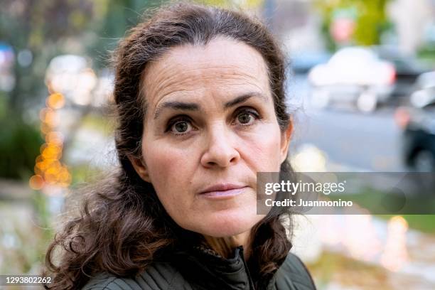serious mature woman looking at the camera out in a suburb - northern european descent stock pictures, royalty-free photos & images