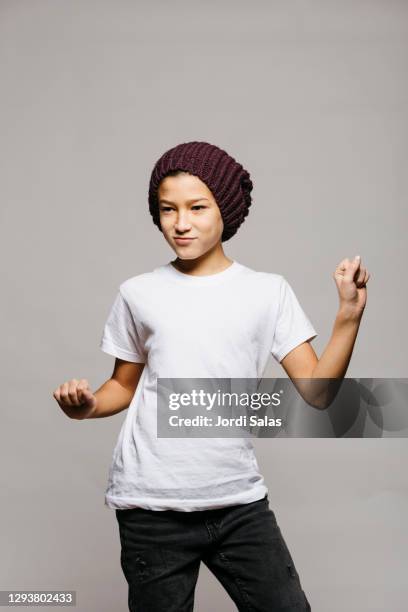 portrait of a boy dancing against a grey background - white people dancing photos et images de collection