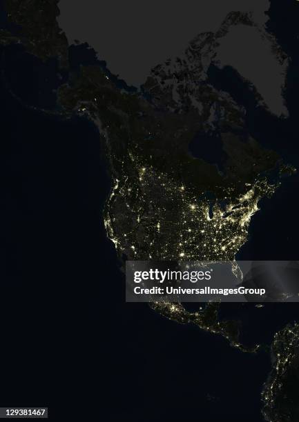 True colour satellite image of North America at night. This image in Lambert Conformal Conic projection was compiled from data acquired by LANDSAT 5...