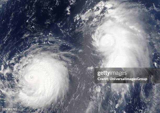 Typhon Mawar and Tropical Cyclone Guchol on 22 August 2005, far out in the northwestern Pacific Ocean, some 900 kilometers from Tokyo. True-colour...