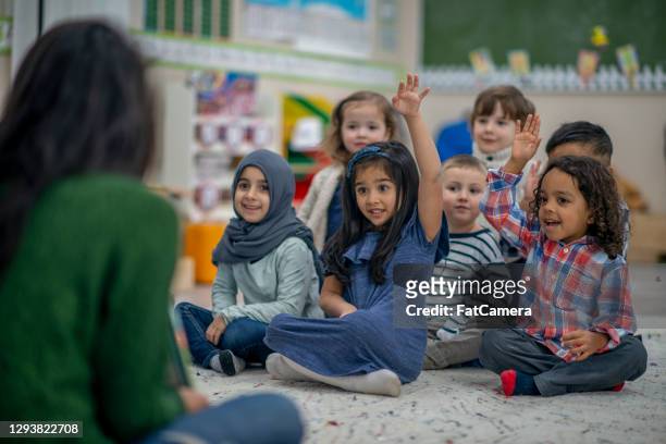 i have a question teacher! - refugee education stock pictures, royalty-free photos & images