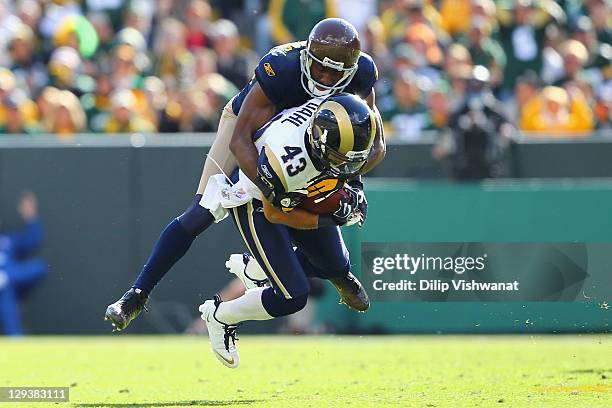 Greg Jennings of the Green Bay Packers tackles Craig Dahl of the St. Louis Rams after Dahl intercepted a pass intended for Jennings at Lambeau Field...