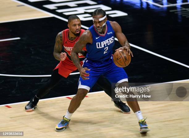 Damian Lillard of the Portland Trail Blazers guards Kawhi Leonard of the LA Clippers during the first half at Staples Center on December 30, 2020 in...
