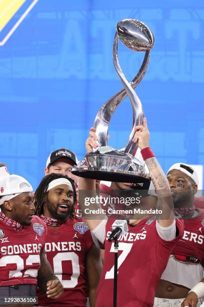 Quarterback Spencer Rattler of the Oklahoma Sooners holds up the Cotton Bowl Championship trophy after defeating Florida Gators 55-20 at AT&T Stadium...