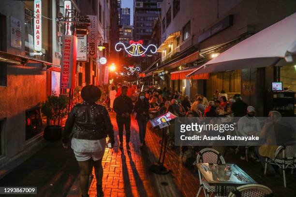 Restaurant-goers are seen in a laneway during New Year's Eve celebrations on December 31, 2020 in Melbourne, Australia. Celebrations look different...