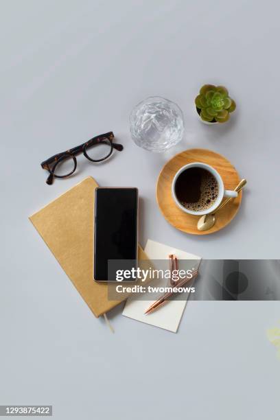 flat lay stylised coffee table top with mobile phone still life. - phone still life stock pictures, royalty-free photos & images