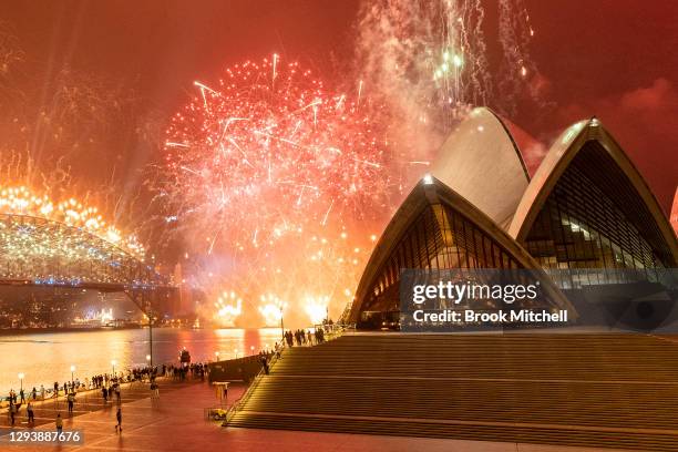 The Sydney Harbour fireworks display is seen over a near-empty Sydney Opera House forecourt during New Year's Eve celebrations on January 01, 2021 in...