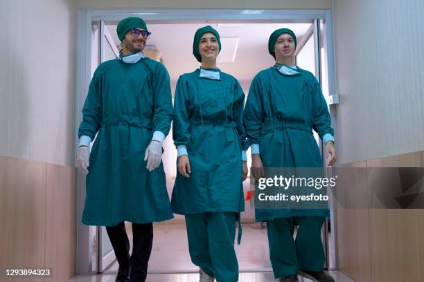 doctors are smiling for success in operating room. - walkout protest stock pictures, royalty-free photos & images